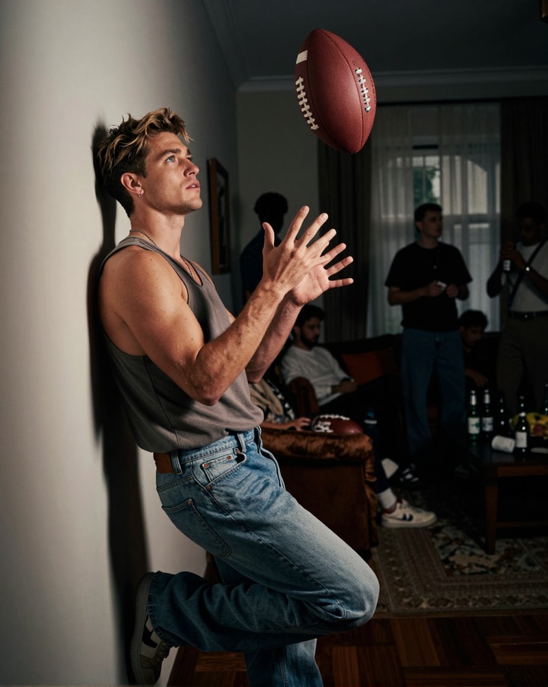 Man catching football in living room